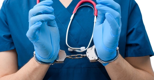 medical professional in police handcuffs